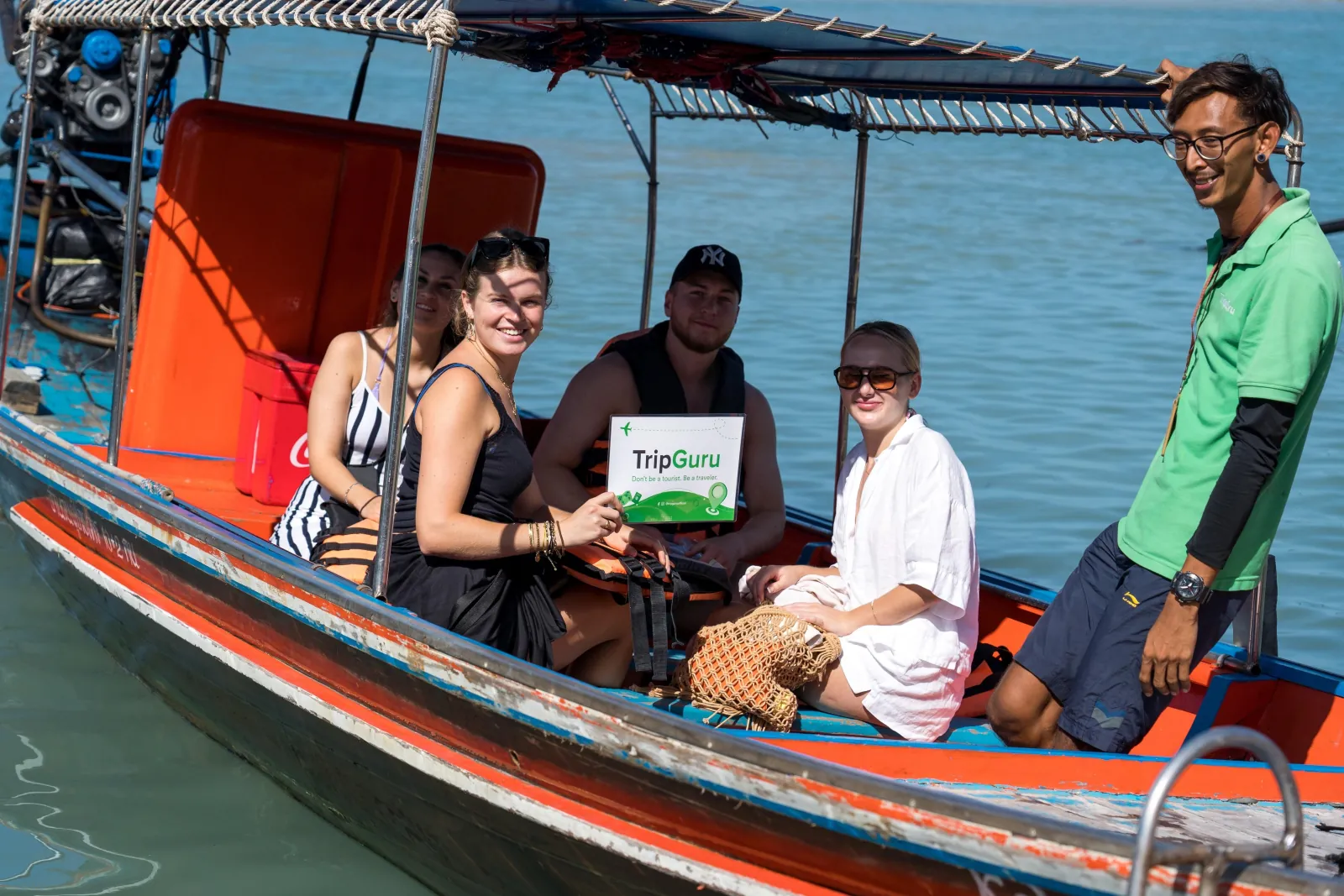 A small group aboard the longtail with their TripGuru guide
